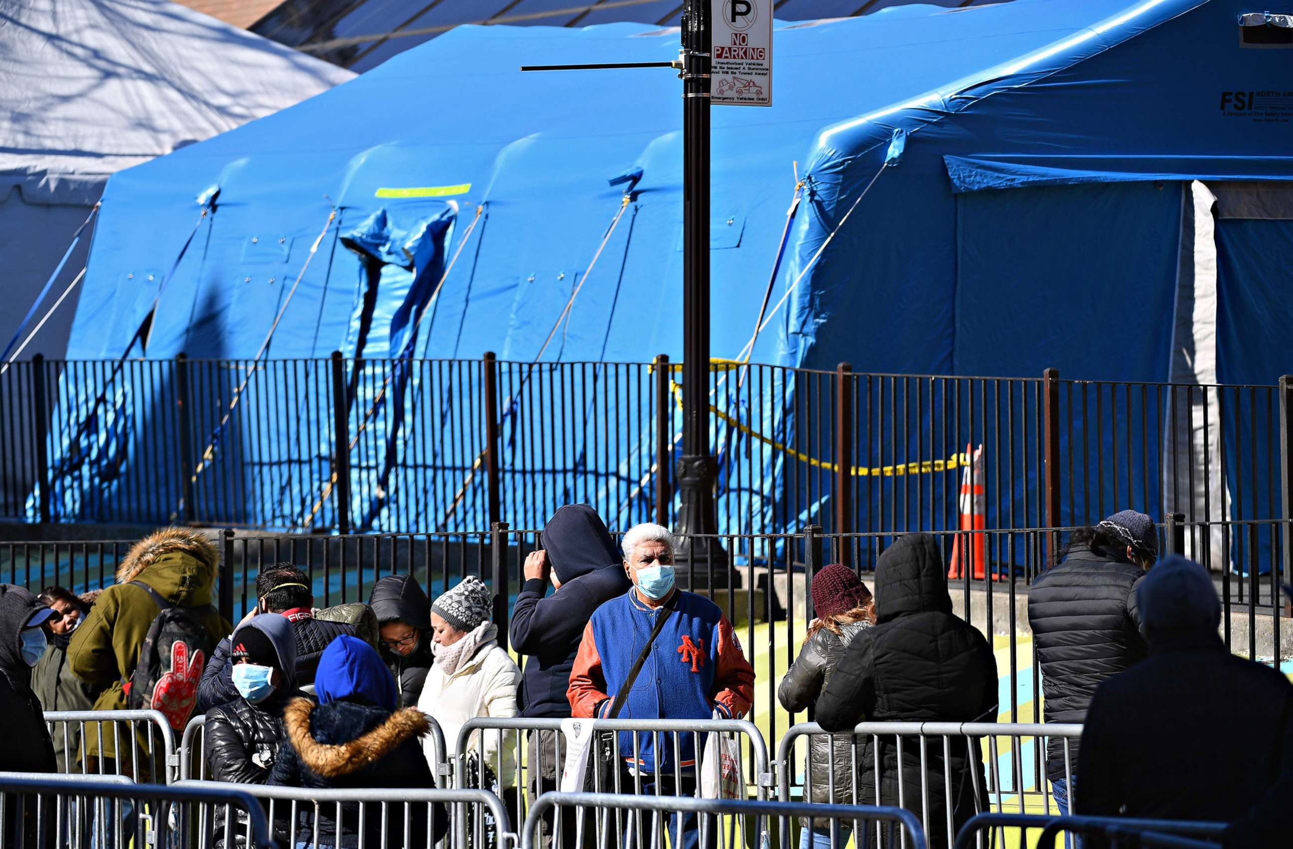 PHOTO: People stand in line to get tested for the coronavirus at Elmhurst Hospital Center, in the Queens borough of New York City on March 26, 2020.