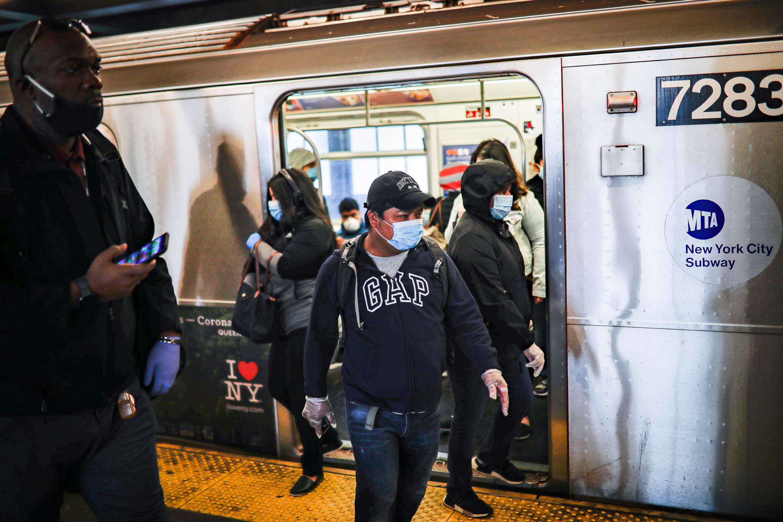 PHOTO: Subway riders step off a train, April 7, 2020, in New York City.