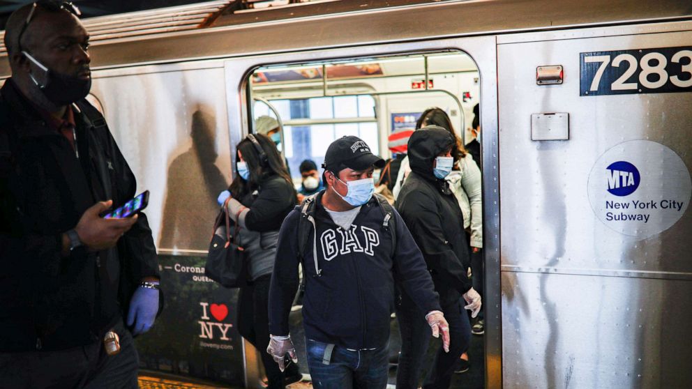 PHOTO: Subway riders step off a train, April 7, 2020, in New York City.