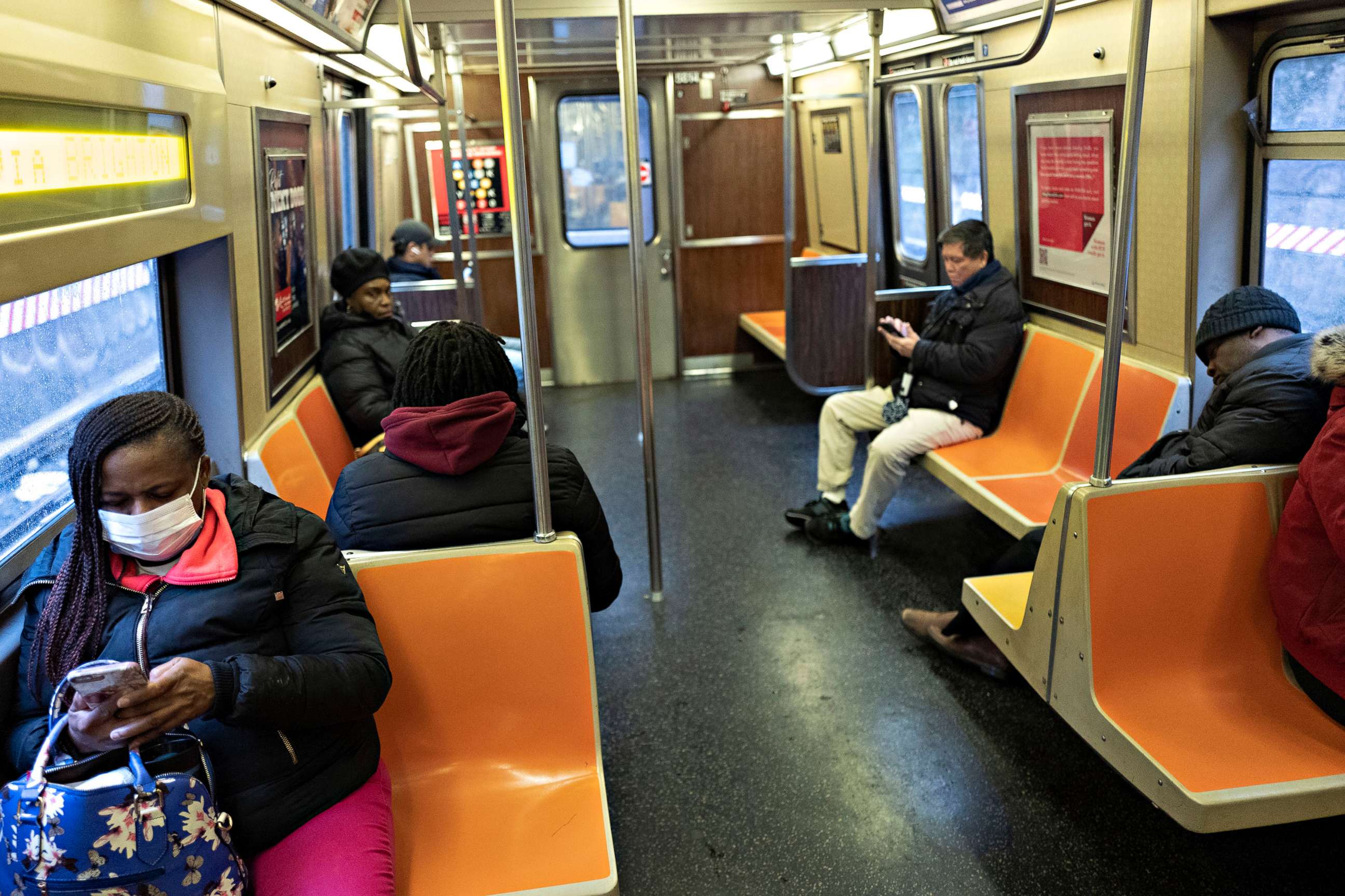 PHOTO: Subway passengers space out their seating during a during rush hour on a subway, March 17, 2020 in New York City. The subway is normally crowded but many people are staying home out of concern for the spread of coronavirus. 