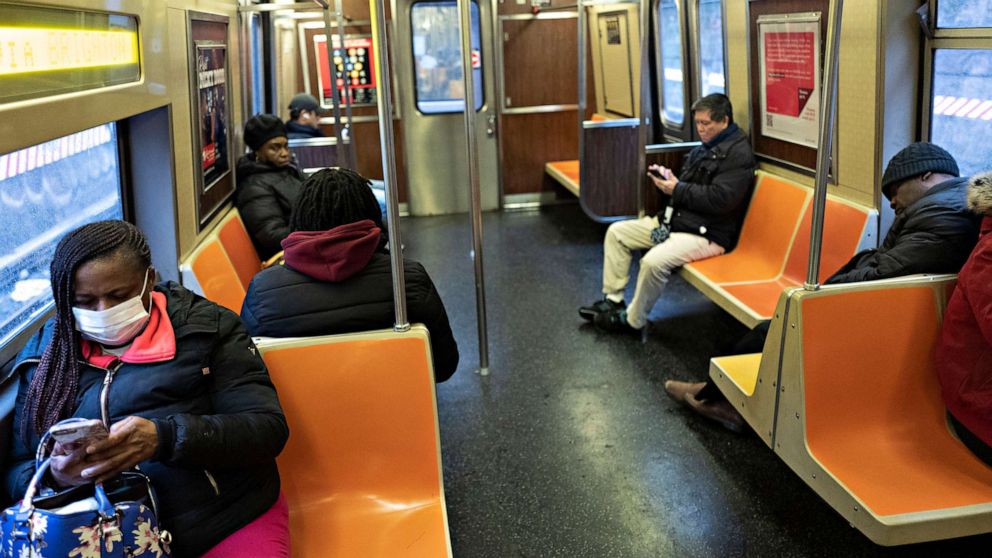 PHOTO: Subway passengers space out their seating during a during rush hour on a subway, March 17, 2020 in New York City. The subway is normally crowded but many people are staying home out of concern for the spread of coronavirus. 