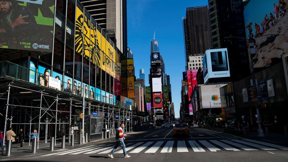 PHOTO: A man crosses a 7 Avenue in a nearly empty Times Square in New York City, March 14, 2020.