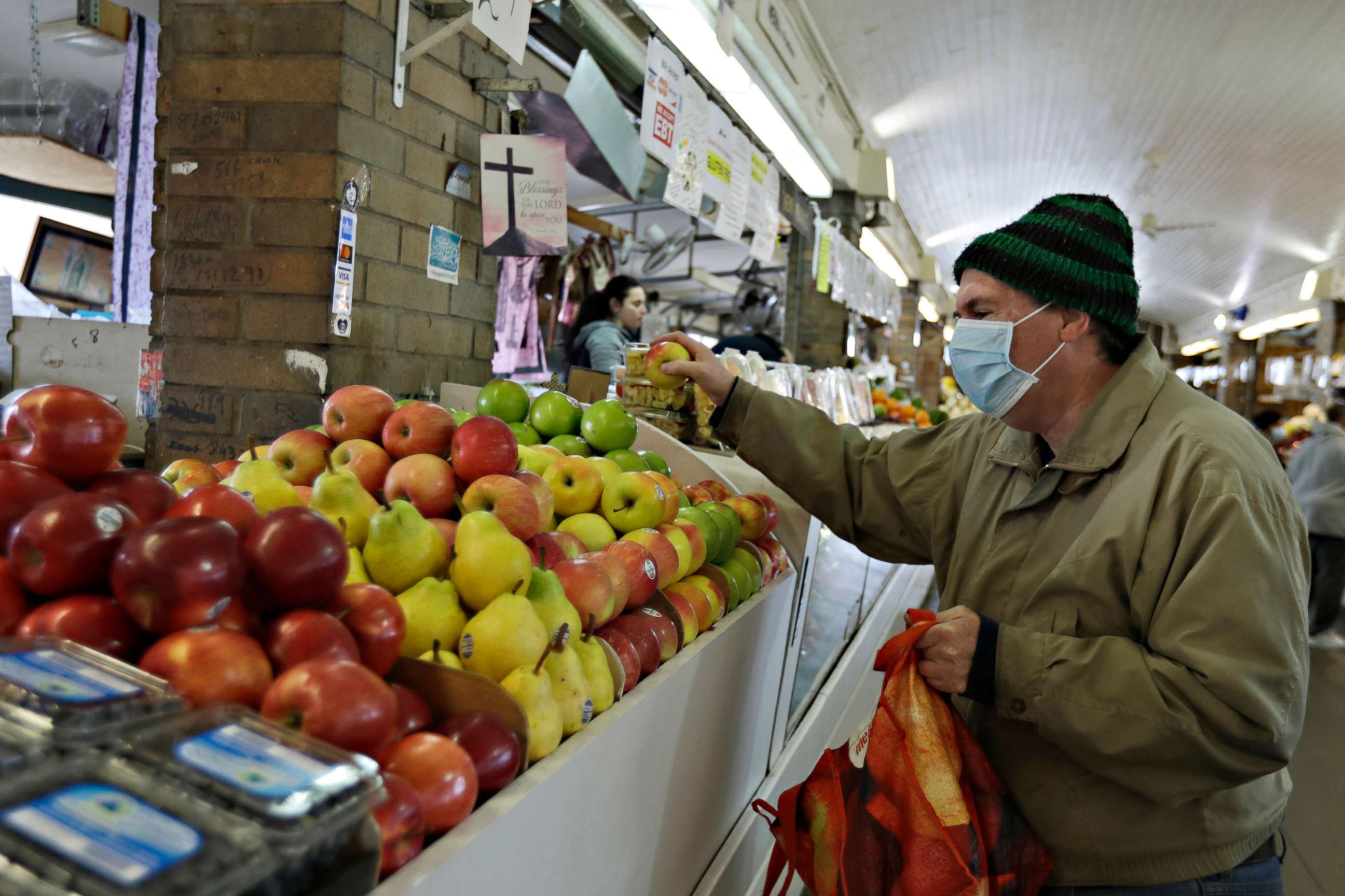 PHOTO: Rick Wittenmyer shops for groceries at the West Side Market, April 10, 2020, in Cleveland.