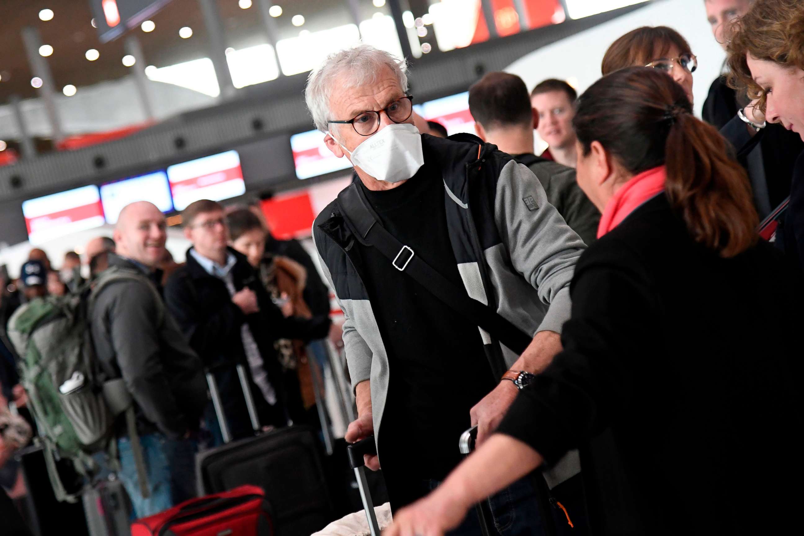 PHOTO: Travelers wait in a check-in line at Paris-Charles-de-Gaulle airport after announcement of a 30-day ban on travel from Europe by President Trump, due to the COVID-19 spread in Roissy-en-France that caused confusion and concern, on March 12, 2020. 