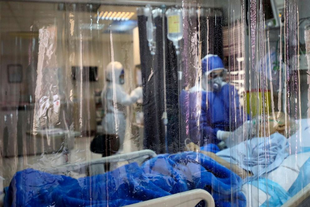 PHOTO: In this photo taken on March 1, 2020, a medic treats a patient infected with the novel coronavirus at a hospital in Tehran, Iran.