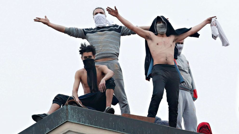 PHOTO: Inmates stand on the roof of the San Vittore prison to protest after restrictions that were imposed on family visits to prevent coronavirus transmissions, in Milan, Italy, March 9, 2020.