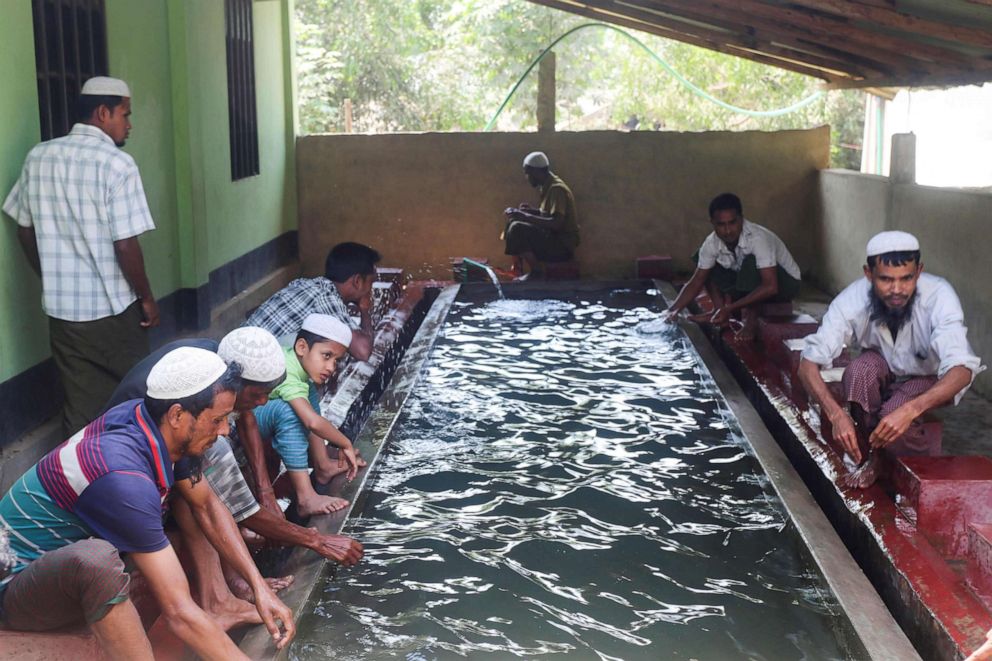 PHOTO: In this picture taken on March 24, 2020, Muslim Rohingya refugees perform ablution before praying in a mosque at Kutupalong refugee camp in Ukhia, Bangladesh.