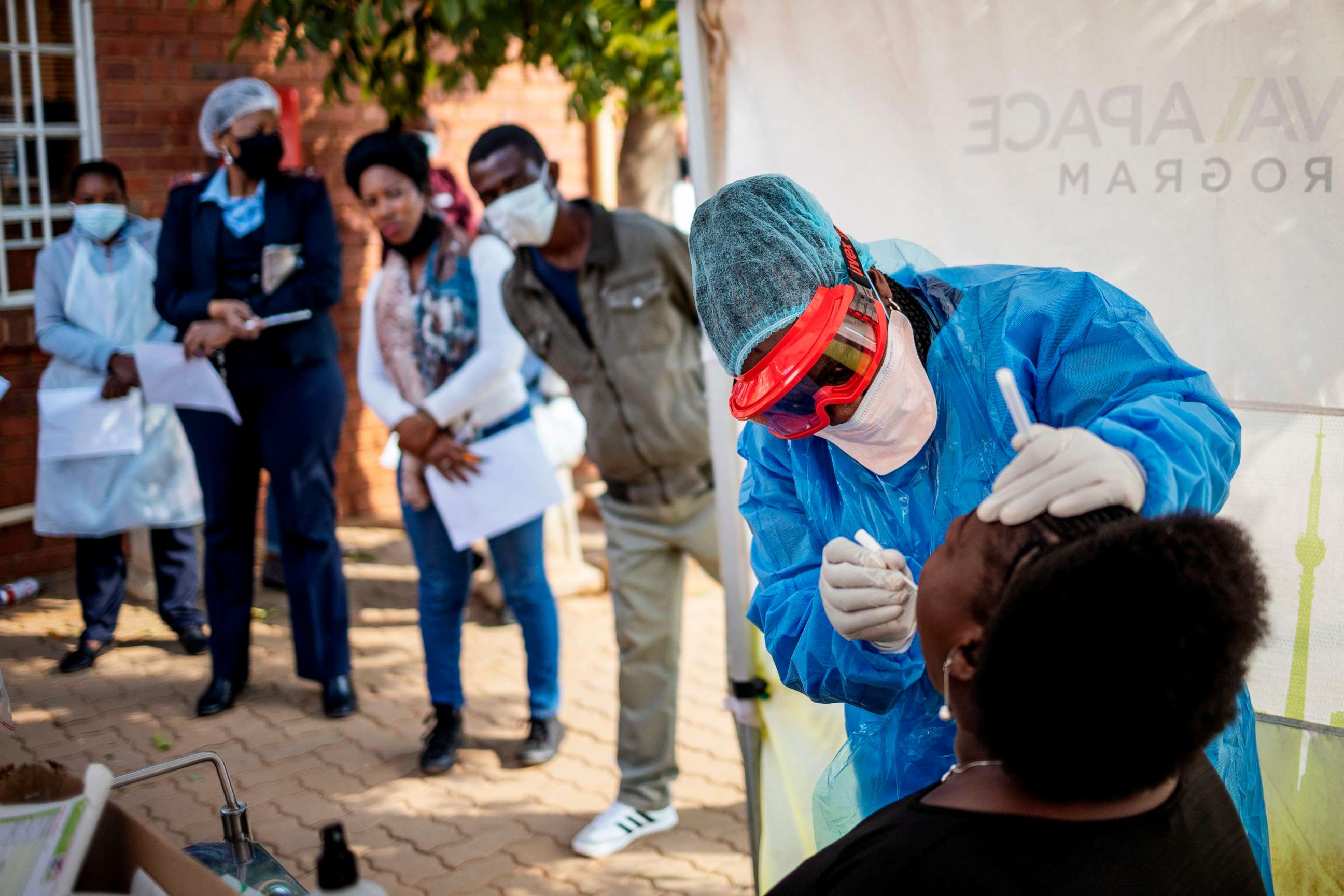 PHOTO: Doctors Without Borders (MSF) nurse Bhelekazi Mdlalose, 51, performs a swab test for COVID-19 coronavirus on a health worker at the Vlakfontein Clinic in Lenasia, Johannesburg, May 13, 2020. 