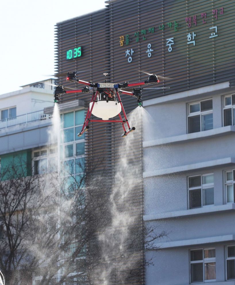 PHOTO: A drone operated by the Suwon municipal government flies around Changyong Middle School spraying disinfectant, in Suwon, South Korea, Feb. 18, 2020.