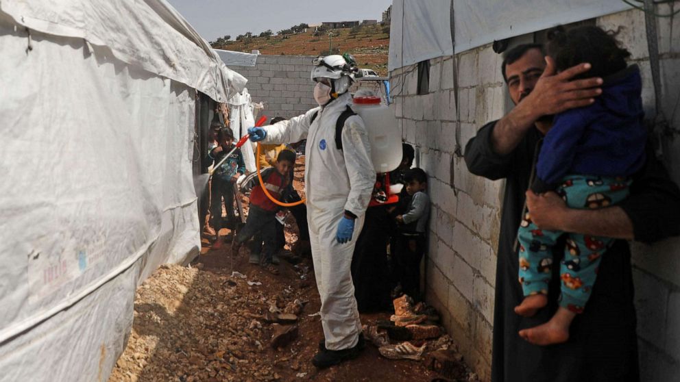 PHOTO: A member of the Syrian Civil Defence, also known as the "White Helmets", disinfects a tent in the Kafr Lusin camp for the displaced by the border with Turkey, in Syria's rebel-held northwestern province of Idlib, on March 24, 2020.