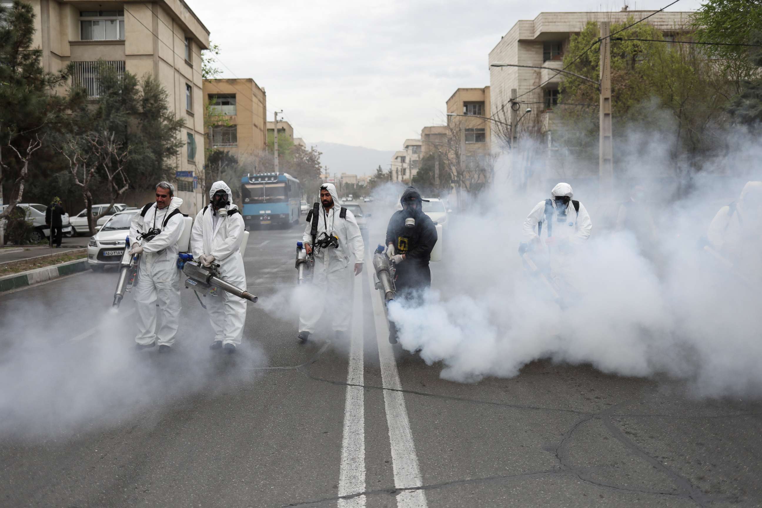 PHOTO: Members of firefighters wear protective face masks, amid fear of coronavirus disease, as they disinfect the streets in Tehran, Iran, March 18, 2020.