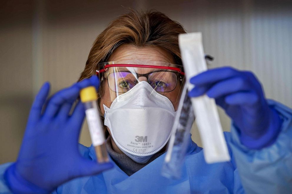 PHOTO: A medical professional displays a test kit to detect the novel coronavirus at a screening-drive at the Amsterdam UMC hospital in Amsterdam, the Netherlands, on March 24, 2020.