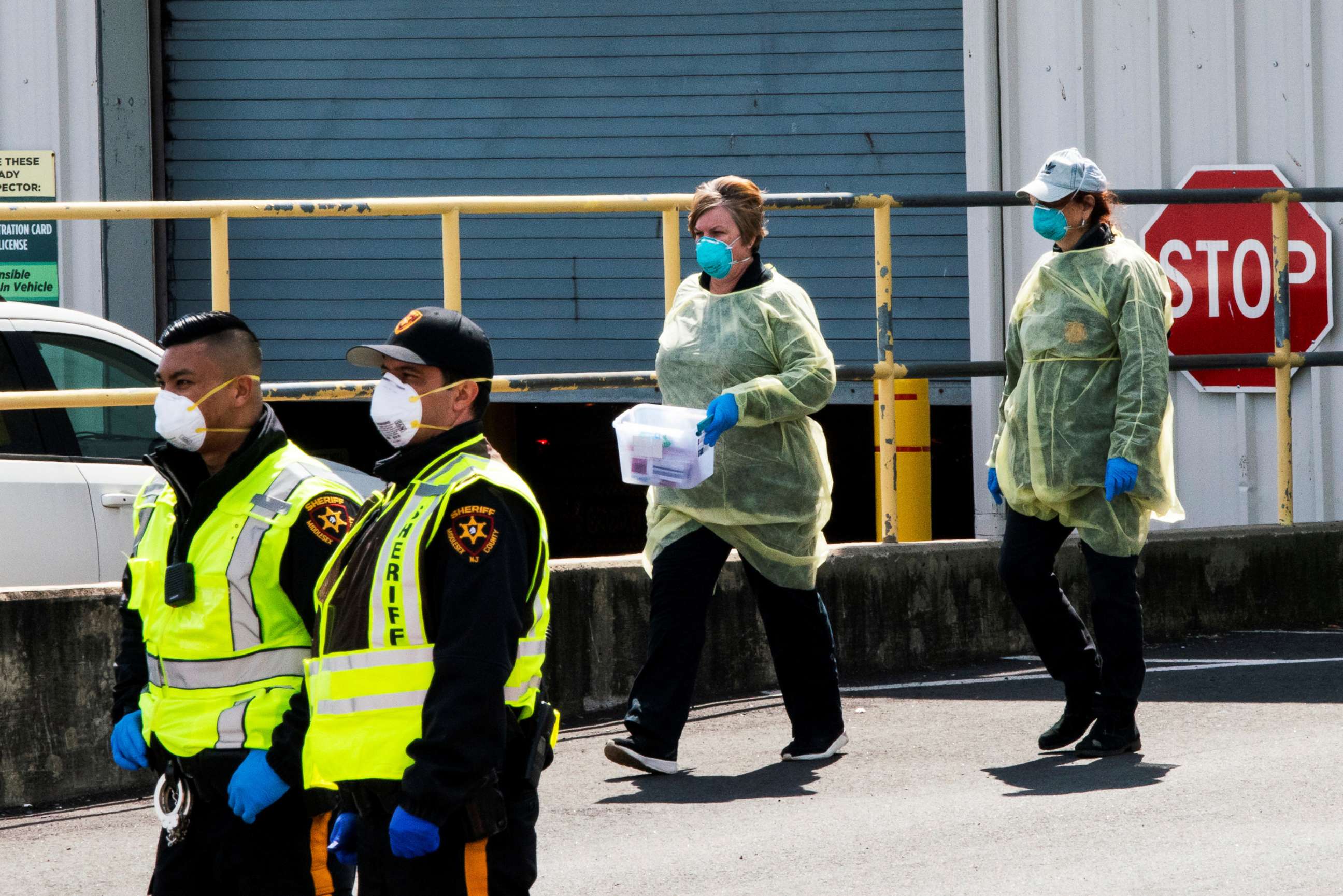 PHOTO: New Jersey police officers and health workers are seen in a newly approved saliva-based COVID-19 testing site during the coronavirus pandemic, in Edison, New Jersey, April 15, 2020.