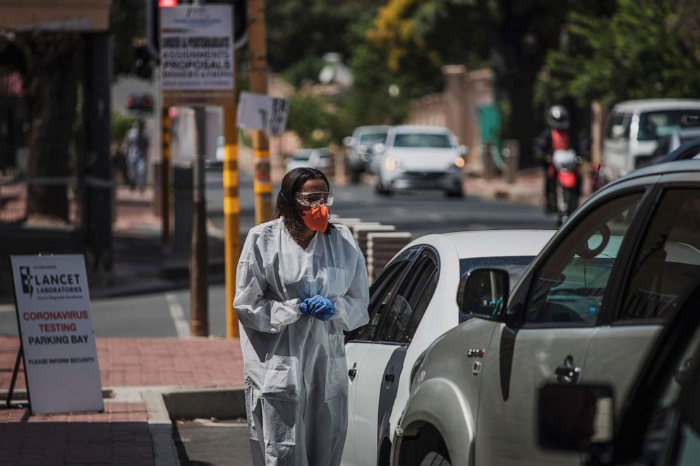PHOTO: A health professional conducts tests for the novel coronavirus at a drive-through testing site outside the Lancet Laboratories facilities in Johannesburg, South Africa, on March 19, 2020.