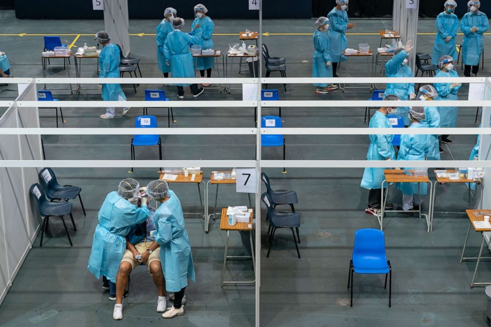 PHOTO: Health care professionals wearing personal protective equipment conduct swab tests at a makeshift COVID-19 testing site within the Queen Elizabeth Stadium in Hong Kong on Sept. 1, 2020.