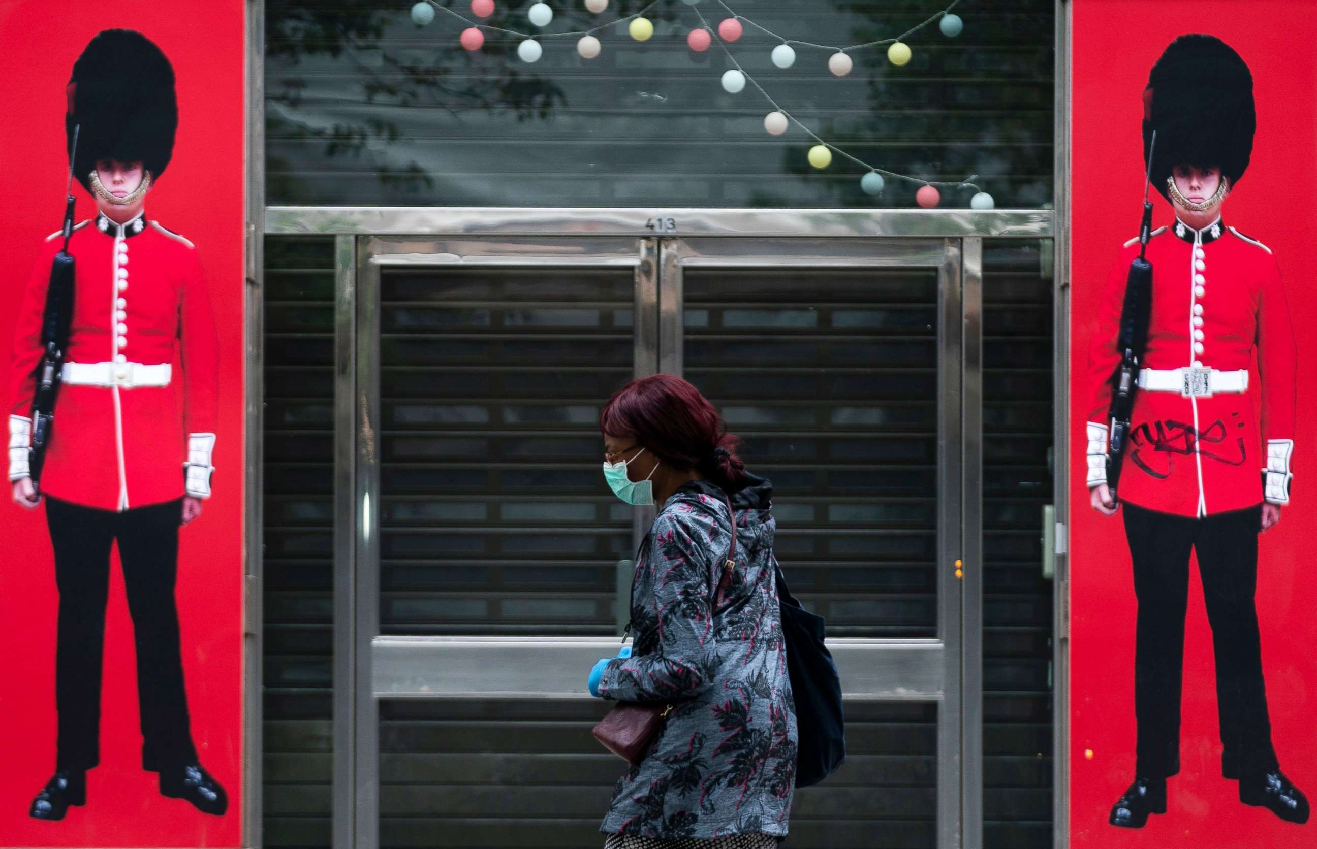 PHOTO: A woman passes a closed shop in Central London, Britain, April 16, 2020. 