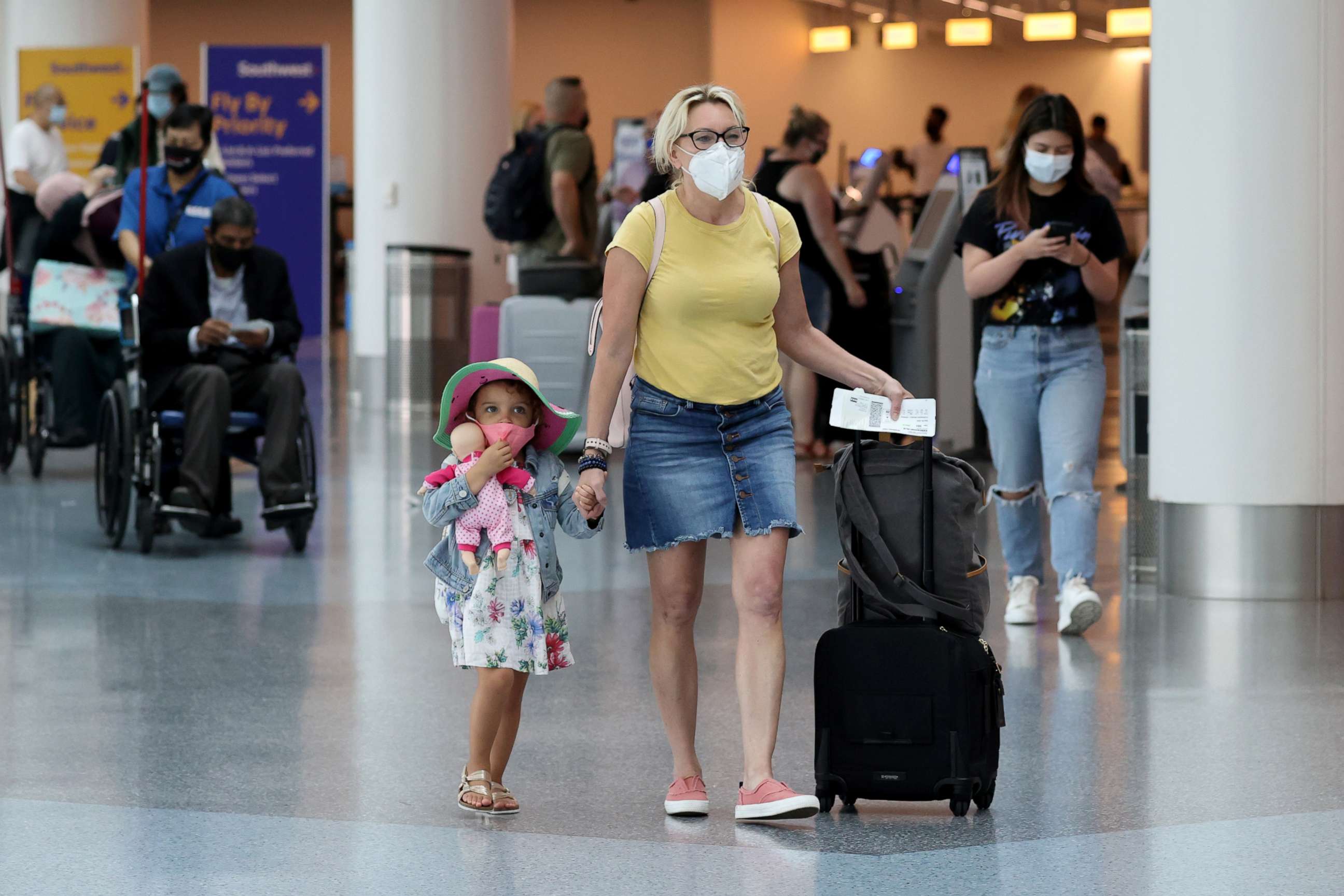 PHOTO: Passengers wear masks as they walk through LAX airport, as the global outbreak of the coronavirus disease (COVID-19) continues, in Los Angeles.