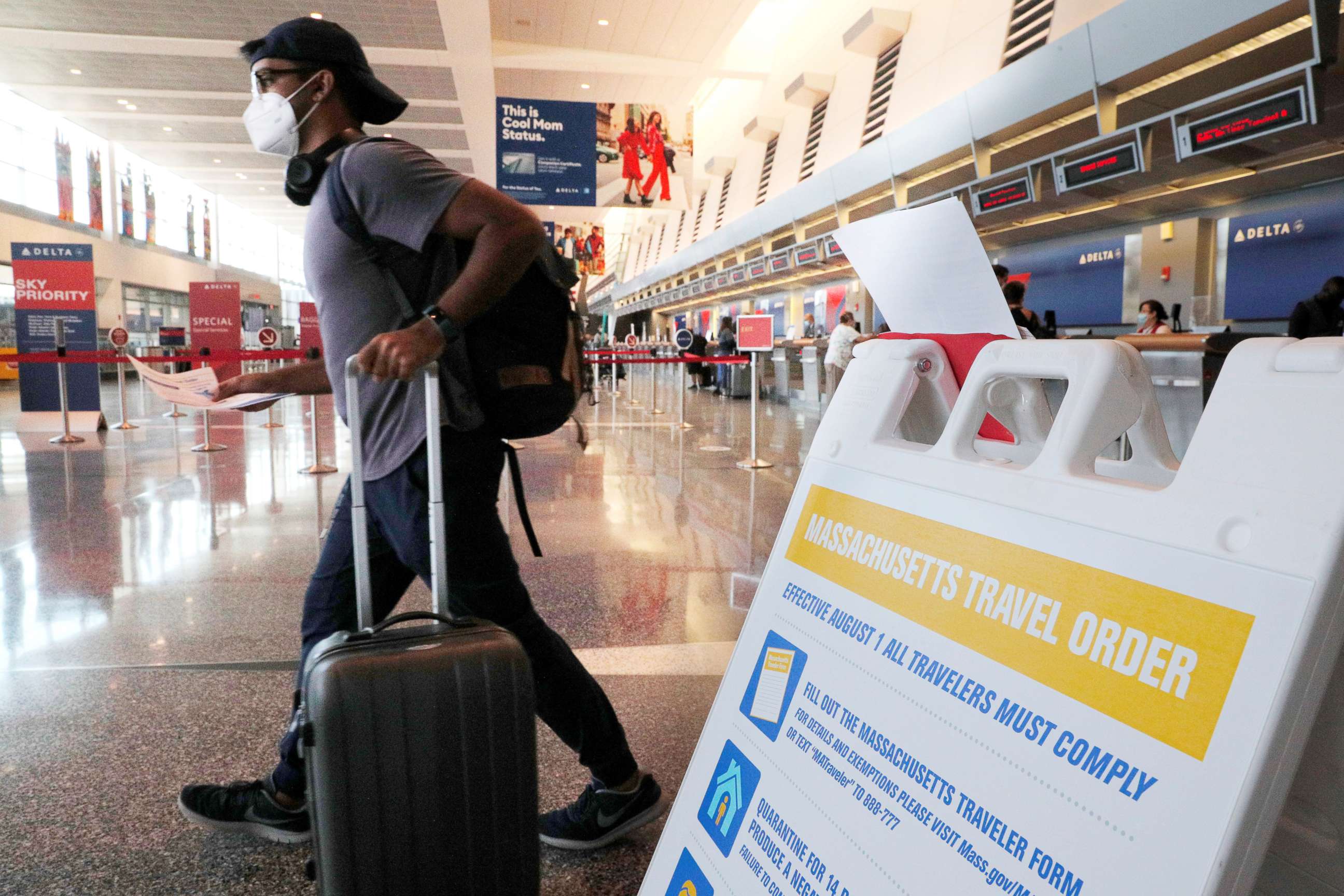 PHOTO: A sign informs travelers arriving at Logan Airport about the restrictions imposed by a Massachusetts Travel Order amid the coronavirus disease (COVID-19) outbreak in Boston, Aug. 3, 2020.