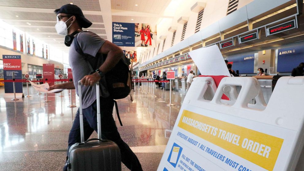 PHOTO: A sign informs travelers arriving at Logan Airport about the restrictions imposed by a Massachusetts Travel Order amid the coronavirus disease (COVID-19) outbreak in Boston, Aug. 3, 2020.