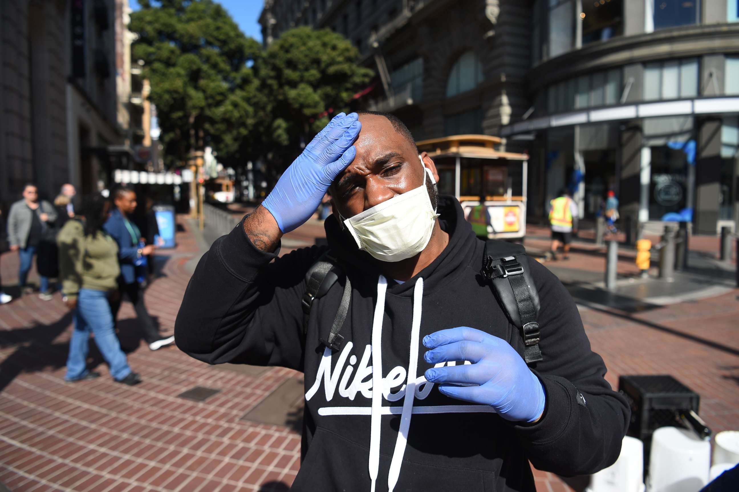 PHOTO: Cameron Nightingale adjusts his mask and gloves, a precaution to protect himself from  coronavirus, in San Francisco on Feb. 27, 2020.