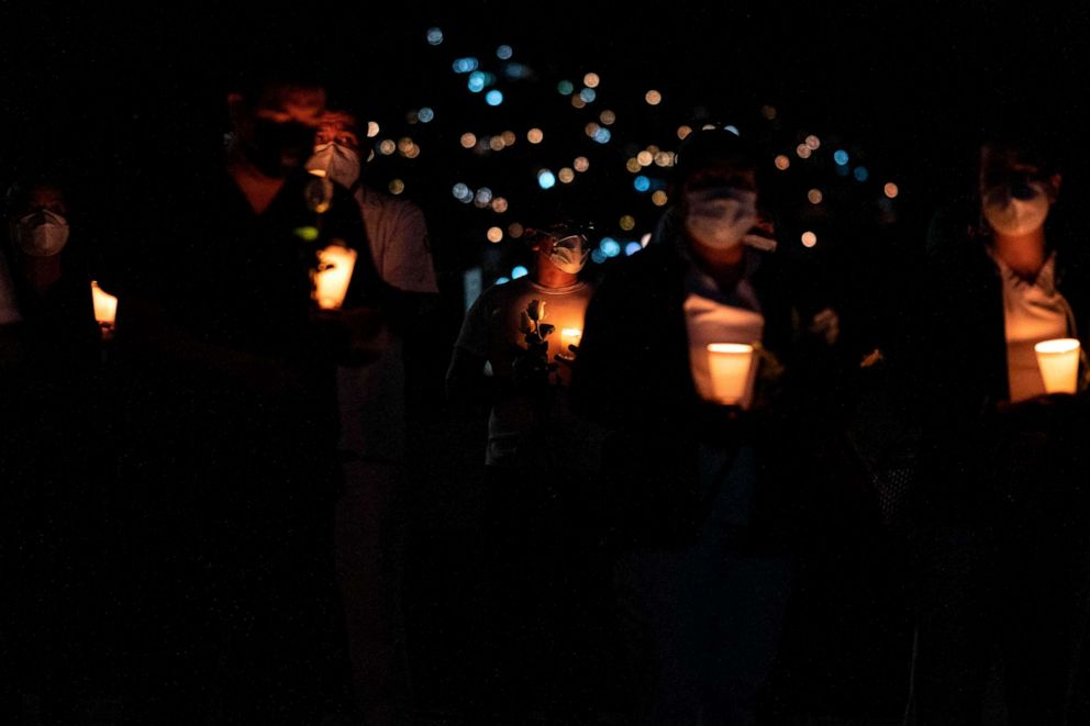 PHOTO: Health workers hold candles during a vigil to honor Manuel de Jesus Merino, a 41-year-old nurse who died of COVID-19 at IMSS Hospital Regional #1 in Tijuana in Mexico's Baja California on June 2, 2020.