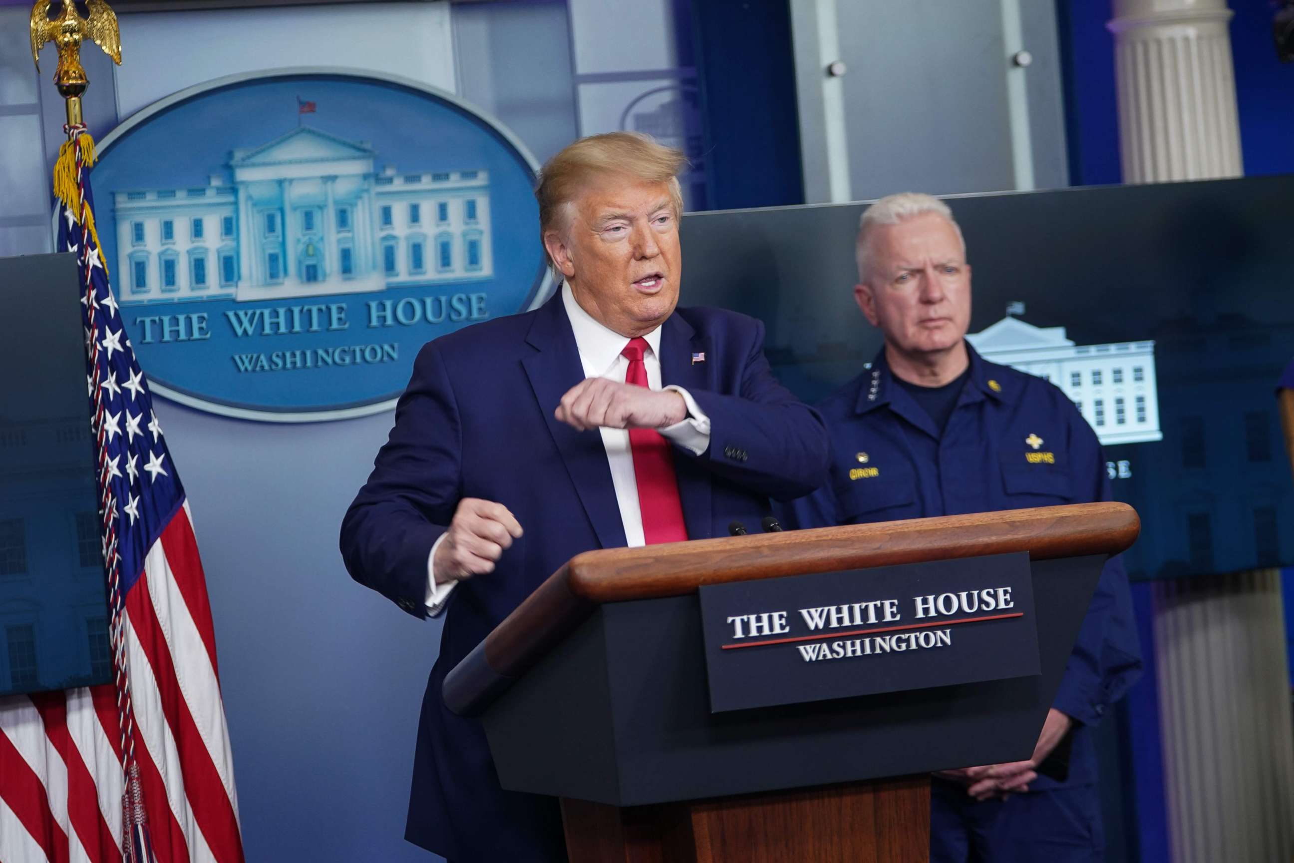 PHOTO: President Donald Trump speaks as Assistant Secretary for Health admiral Brett Giroir listens during the daily briefing on the novel coronavirus, COVID-19, in the Brady Briefing Room at the White House on April 6, 2020, in Washington.