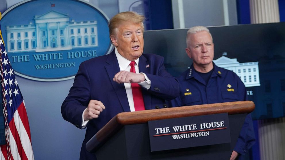 PHOTO: President Donald Trump speaks as Assistant Secretary for Health admiral Brett Giroir listens during the daily briefing on the novel coronavirus, COVID-19, in the Brady Briefing Room at the White House on April 6, 2020, in Washington.