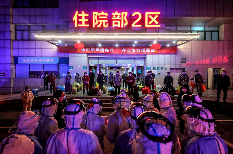 PHOTO: Patients infected by the COVID-19 coronavirus (facing camera) wait to be transferred from Wuhan No.5 Hospital to Leishenshan Hospital, the newly-built hospital for COVID-19 patients, in Wuhan in China's central Hubei province on March 3, 2020.