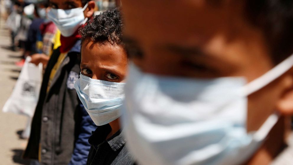 PHOTO: Orphans wear masks they received as an aid against the coronavirus in an orphan center in Sanaa, Yemen, March 23, 2020.