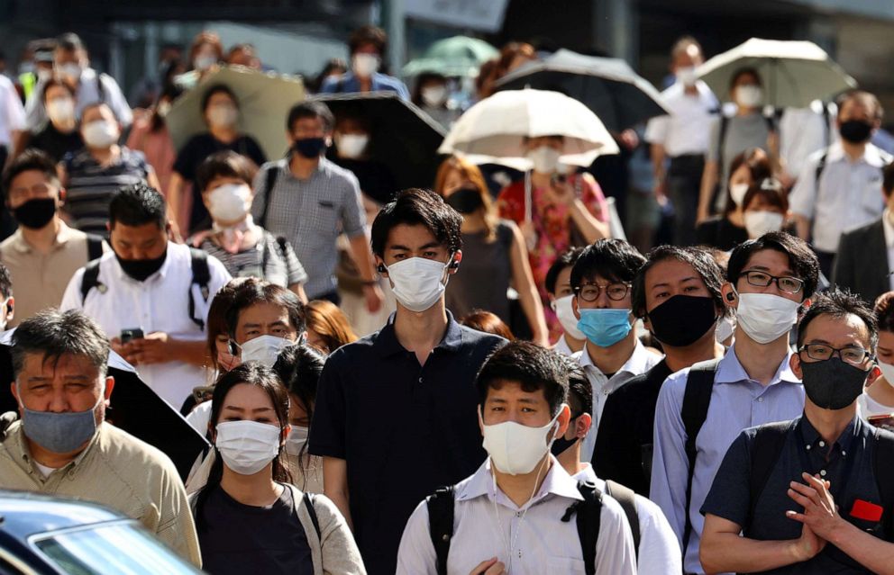 PHOTO: People wearing protective masks, amid the coronavirus disease (COVID-19) outbreak, make their way in Tokyo, Japan, August 6, 2021.