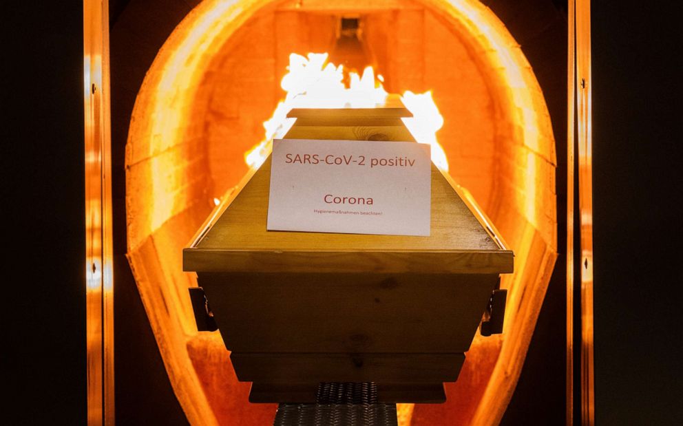 PHOTO: A coffin labeled "SARS-CoV-2 positive - Corona" is cremated in a crematorium in Giesen, Germany, on Nov. 25, 2021.