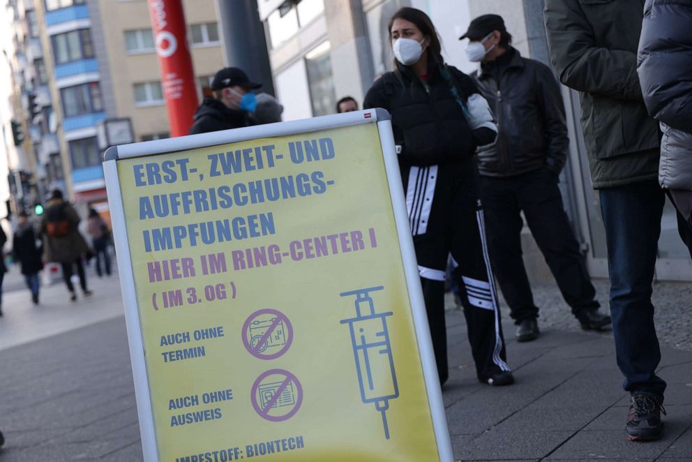 PHOTO: People wait in line to be vaccinated against Covid-19 outside a newly-opened vaccination center in the Ring-Center shopping mall, Nov. 26, 2021, in Berlin.