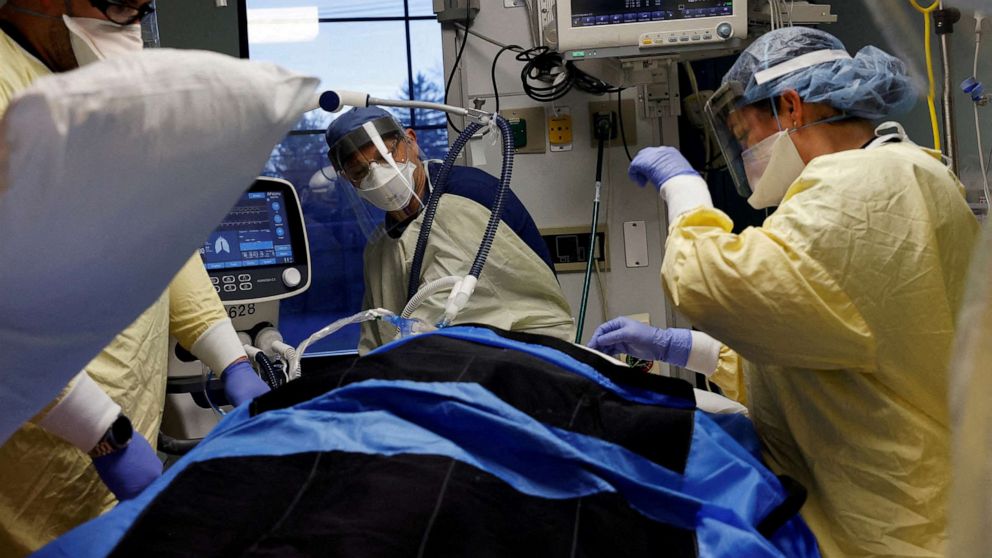 PHOTO: Medical staff treat a COVID-19 patient in their isolation room in the ICU at Western Reserve Hospital in Cuyahoga Falls, Ohio, Jan. 4, 2022.