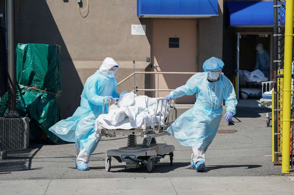 PHOTO: Bodies are moved to a refrigeration truck serving as a temporary morgue at Wyckoff Hospital, April 6, 2020 in Brooklyn, New York.