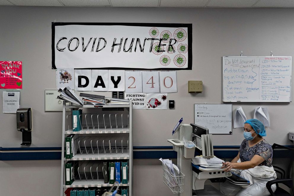PHOTO: A medical staff member works on a computer as the number on the wall indicates the days since the hospital opened its COVID-19 unit at United Memorial Medical center on November 14, 2020, in Houston.