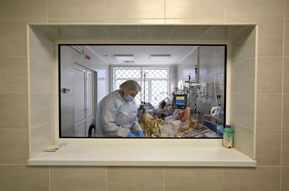 FILE PHOTO: A health care worker provides medical assistance to a COVID-19 patient inside the intensive care unit at a hospital that treats patients infected with the novel coronavirus in Kiev, Ukraine, on Nov. 1, 2021.