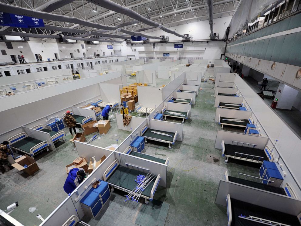 PHOTO: Workers set up beds to convert an exhibition centre into a makeshift hospital, following the COVID-19 outbreak in Changchun, Jilin province, China on March 12, 2022.