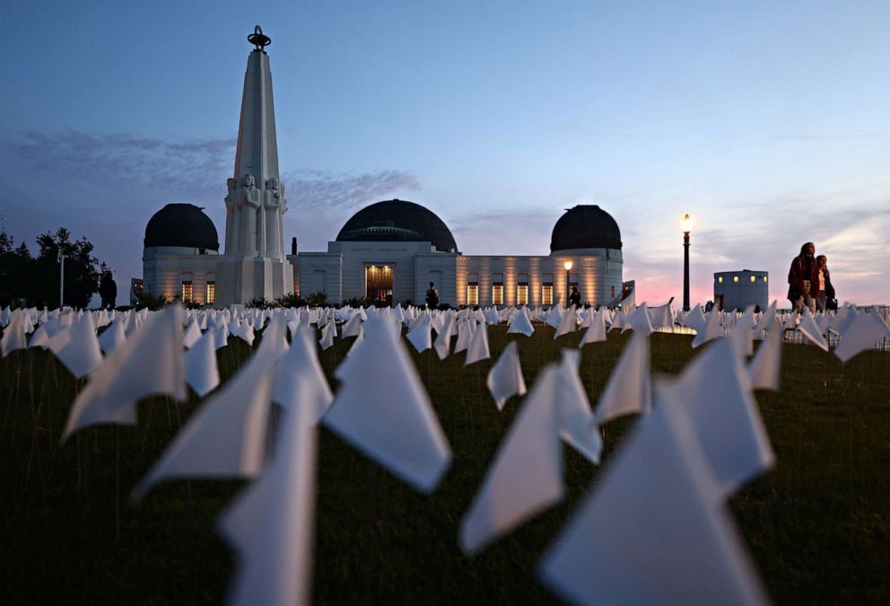 PHOTO: A white flag memorial installation honoring the nearly 27,000 Los Angeles County residents who have died from COVID-19 stands outside Griffith Observatory on Nov. 18, 2021, in Los Angeles, Calif.