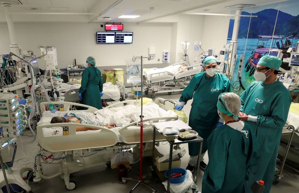 PHOTO: Health workers take care of patients suffering from the coronavirus disease in a recovery room of an operating theatre transformed for COVID-19 patients, at Montlegia CHC clinic in Liege, Belgium, Oct. 29, 2020.
