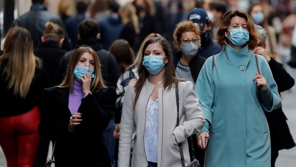 PHOTO: People wearing protective masks walk along the principal shopping street of Via del Corso, as the number of people infected by COVID-19 continues to rise, in Rome, Nov. 14, 2020.