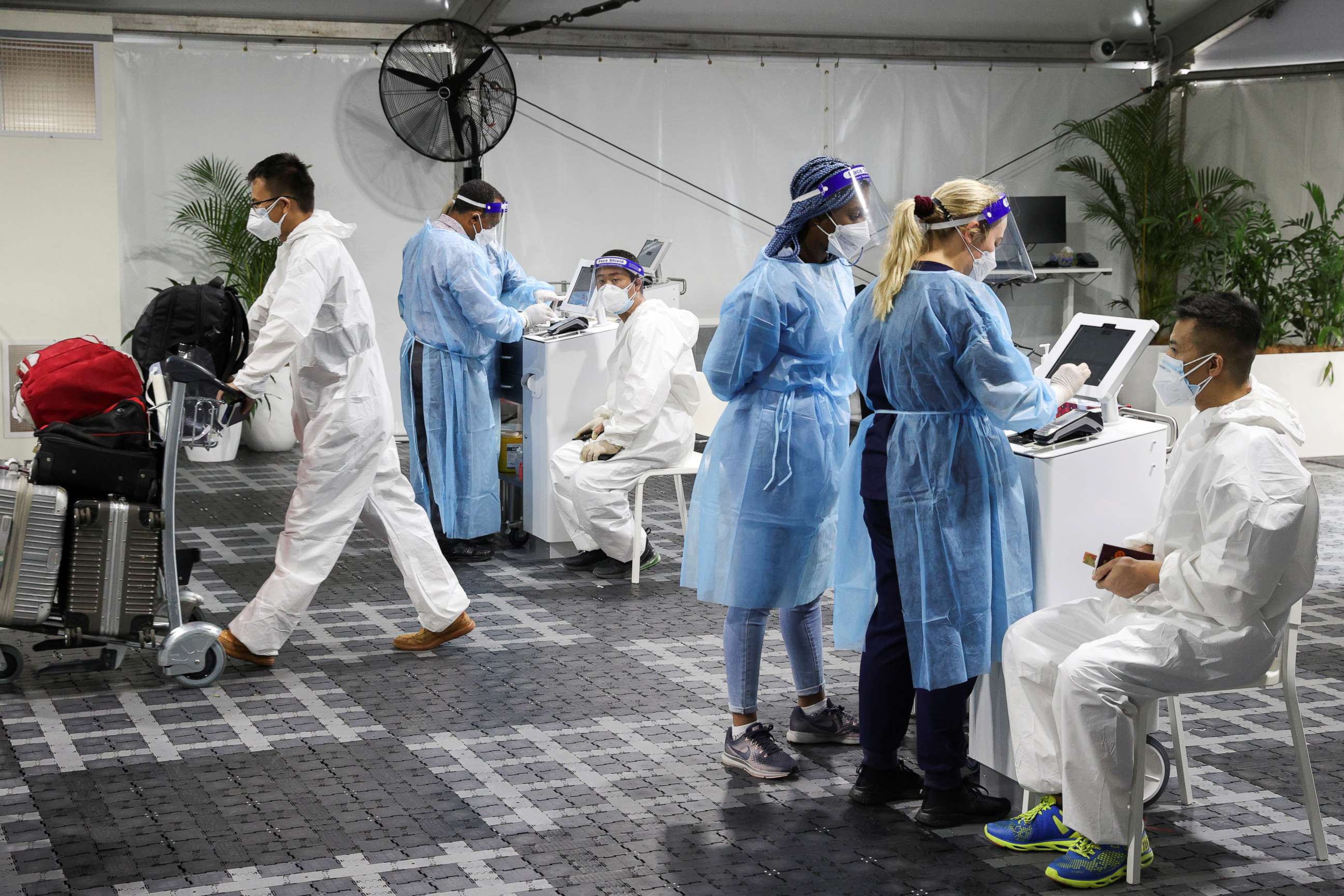 PHOTO: Travelers get tested for COVID-19 at a pre-departure testing facility outside the international terminal at Sydney Airport in Sydney, Australia, on Nov. 29, 2021, as countries react to the new omicron variant.