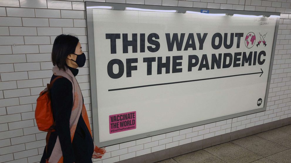 PHOTO: A woman walks past a sign amidst the spread of the coronavirus disease (COVID-19), in London, Jan. 24, 2022.