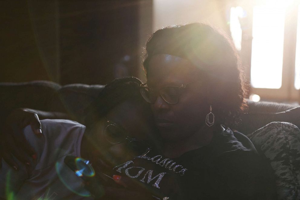 PHOTO: Justise McGowan, 13, rests her head on her mother, Dr. Sandra McGowan-Watts, at home in Matteson, Ill., March 16, 2022. 