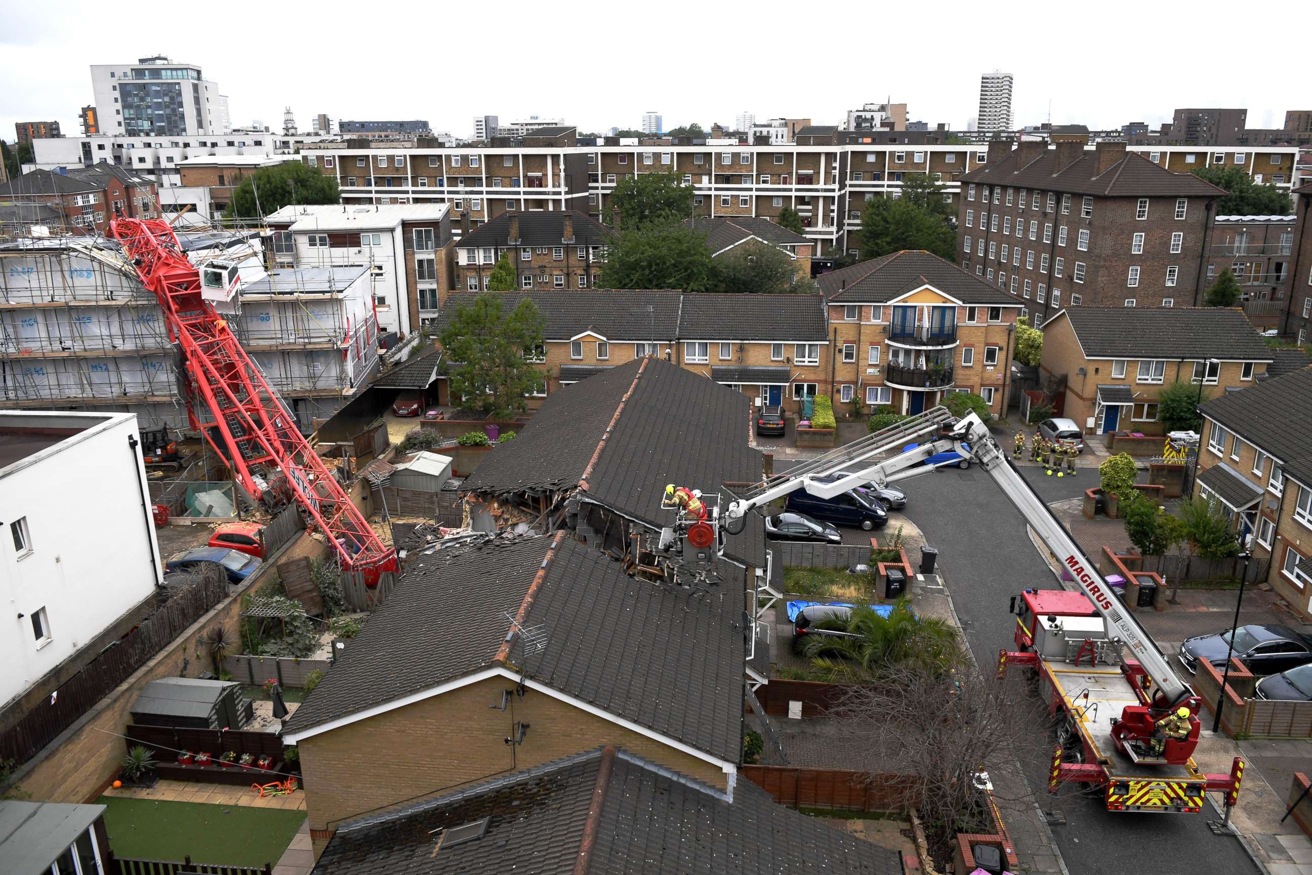 PHOTO: Emergency crews at the scene where a 20-metre crane collapsed on onto a terraced house in East London on July 8, 2020 in Bow, England.