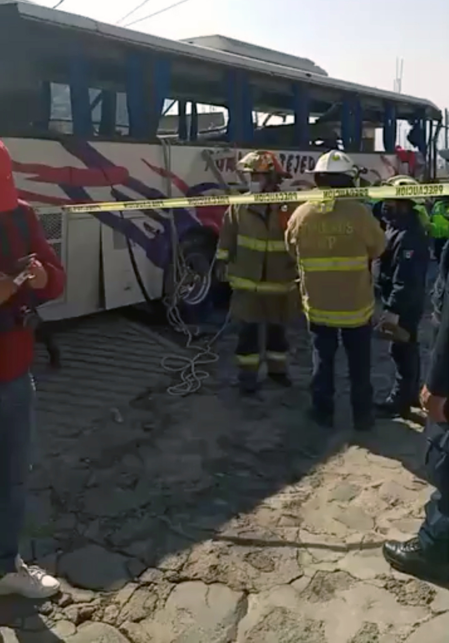 PHOTO: Firefighters stand next to a bus at a crash site in Joquicingo, near Mexico City, Nov. 26, 2021, in this screen grab obtained from a social media video.