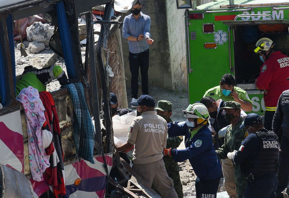 PHOTO: Rescuers and authorities remove a body in the area of the accident in Joquicingo, near Mexico City, Nov. 26, 2021.