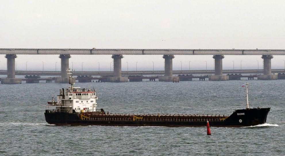 PHOTO: A ship makes its way near to the Kerch bridge, in background, near in to Kerch, Crimea, Nov. 26, 2018.