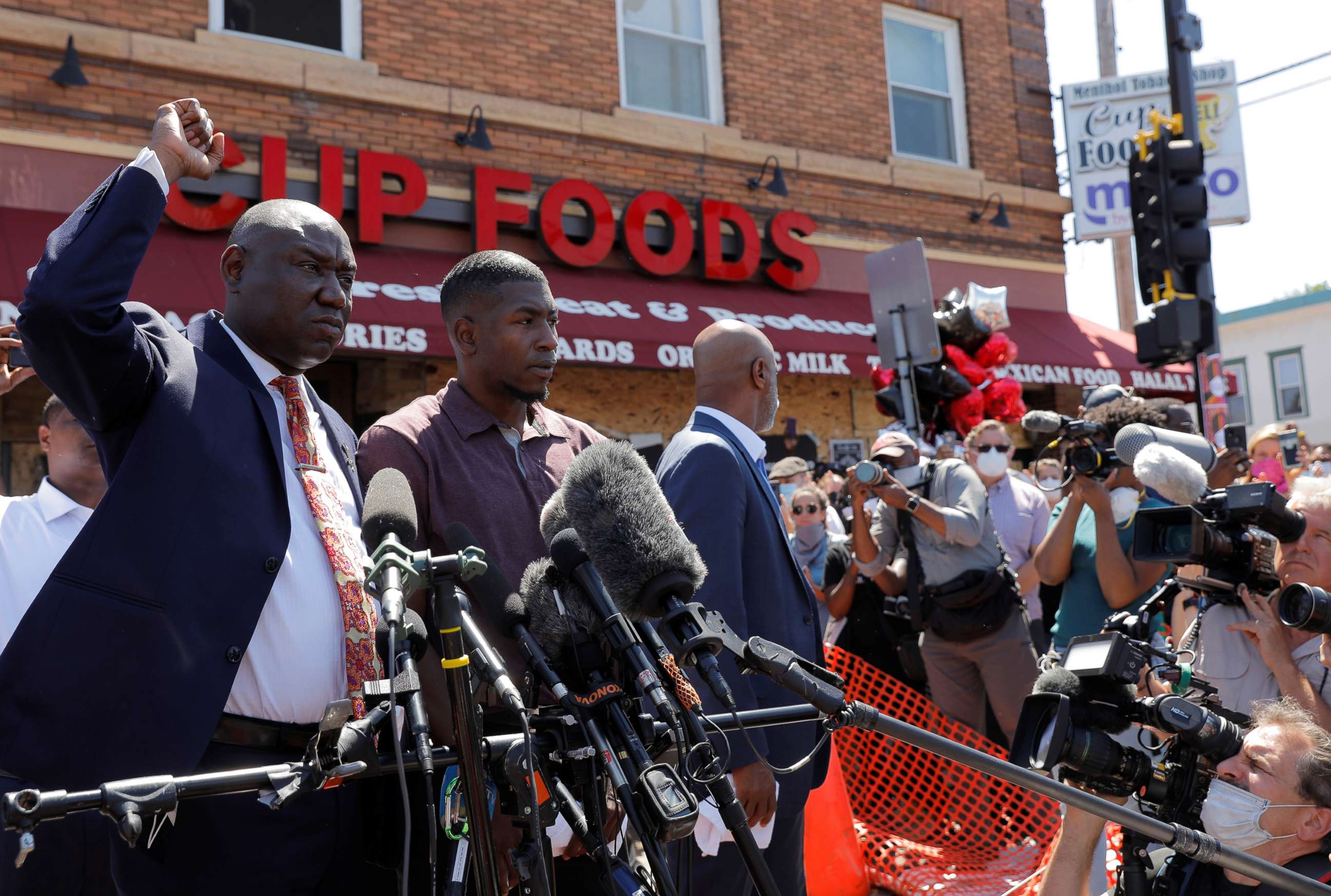 PHOTO: Civil rights attorney Ben Crump gestures next to George Floyd's son, Quincy Mason Floyd, as they visit the site where George Floyd was taken into police custody, in Minneapolis, June 3, 2020.