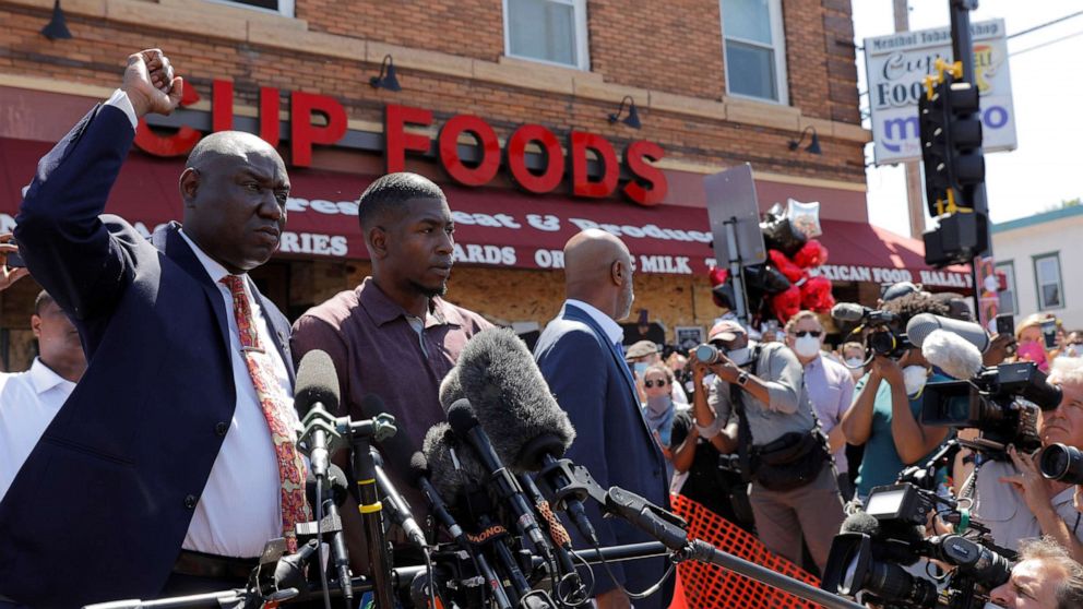 PHOTO: Civil rights attorney Ben Crump gestures next to George Floyd's son, Quincy Mason Floyd, as they visit the site where George Floyd was taken into police custody, in Minneapolis, June 3, 2020.