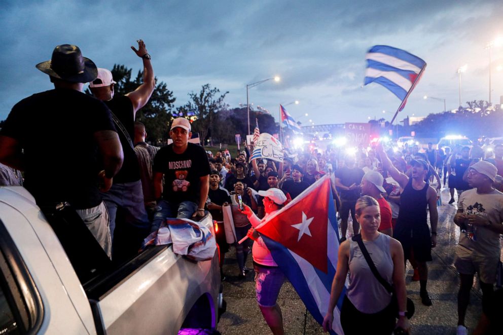 PHOTO: People hold Cuban flags as they block Dale Mabry Highway during a protest against the Cuban government, in Tampa, Fla., July 13, 2021.